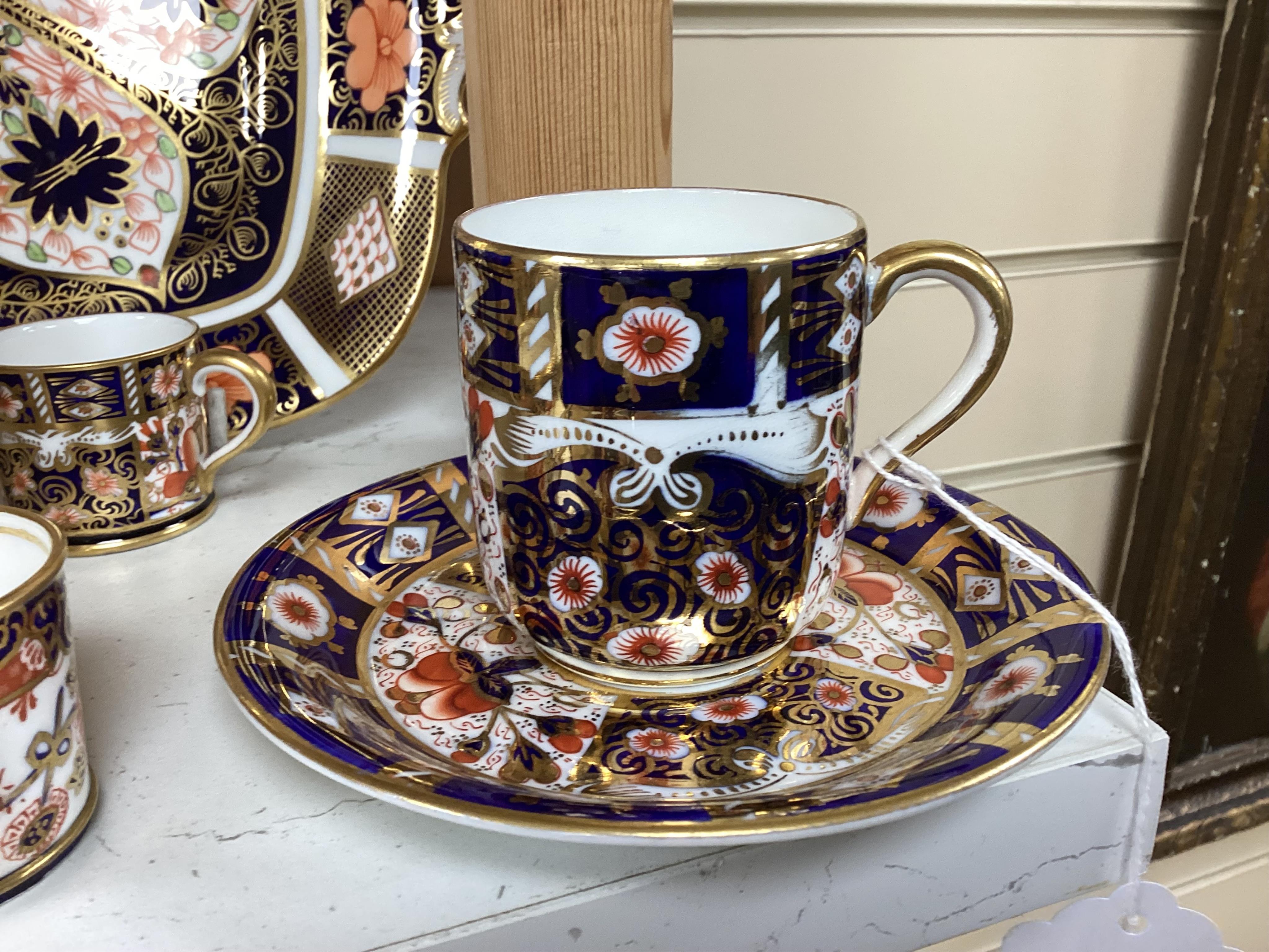 A quantity of Royal Crown Derby Imari to include a sandwich plate, cups and saucers and and miniature twin handled cups, largest 27cm in diameter